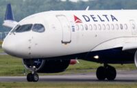 A Delta Air Lines aircraft parked at an airport while its passengers disembark