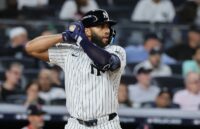The experienced player holding the bat, ready to make a hit
