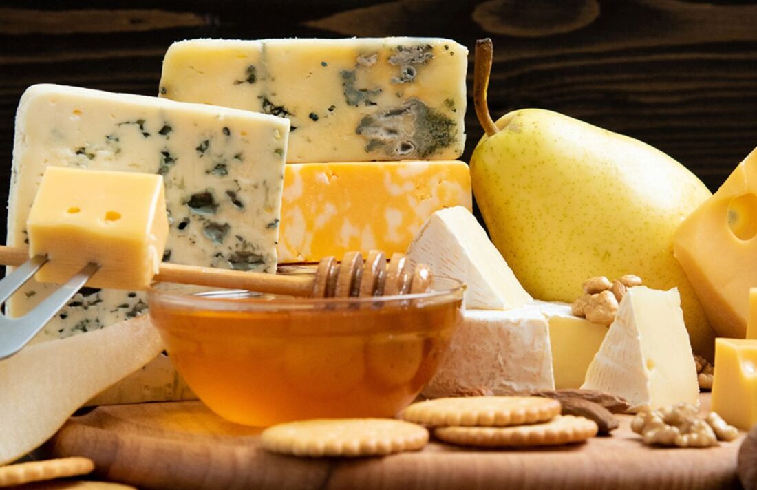 Various types of cheese on wooden boards on a table