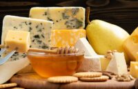 Various types of cheese on wooden boards on a table