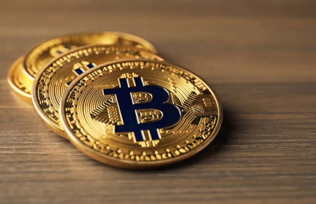 Couple kidnapped in their home and robbed of €8 million in cryptocurrencies Three stacked Bitcoin coins on a table