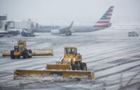 An airport covered in snow, preventing any planes from taking off