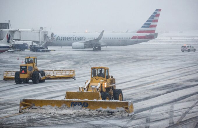 An airport covered in snow, preventing any planes from taking off