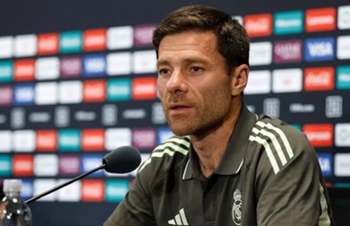 The former player and now Spanish coach sitting at a press conference giving explanations about the match