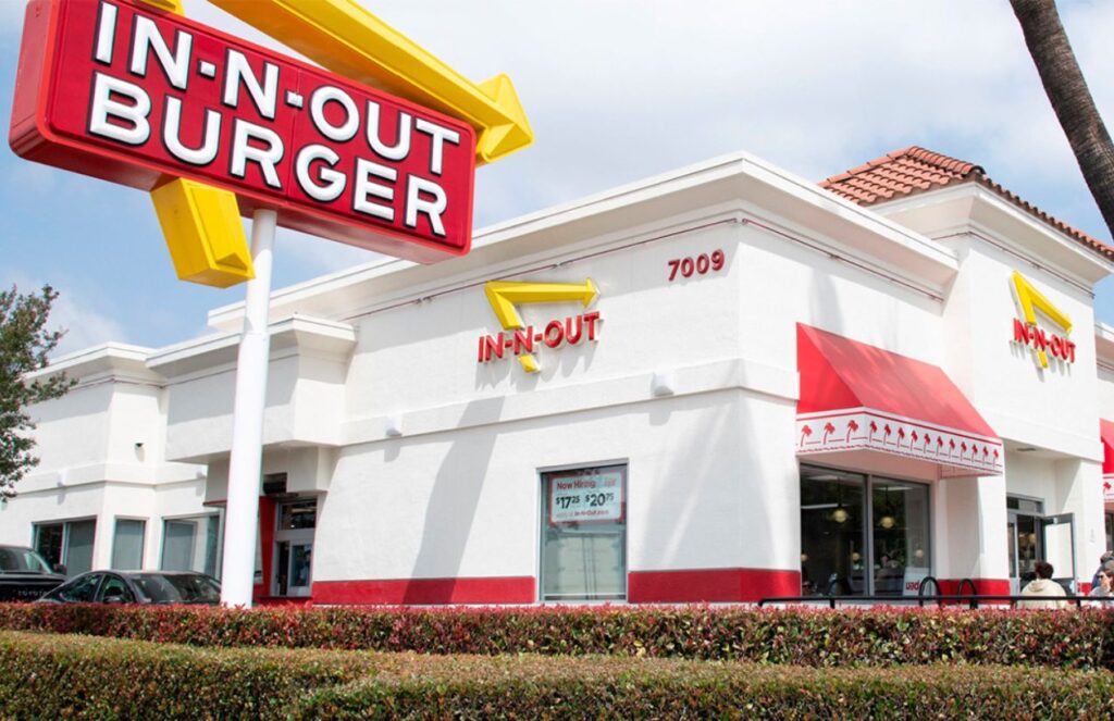 One of the In-N-Out stores with its white facade and its logo in yellow and red colors
