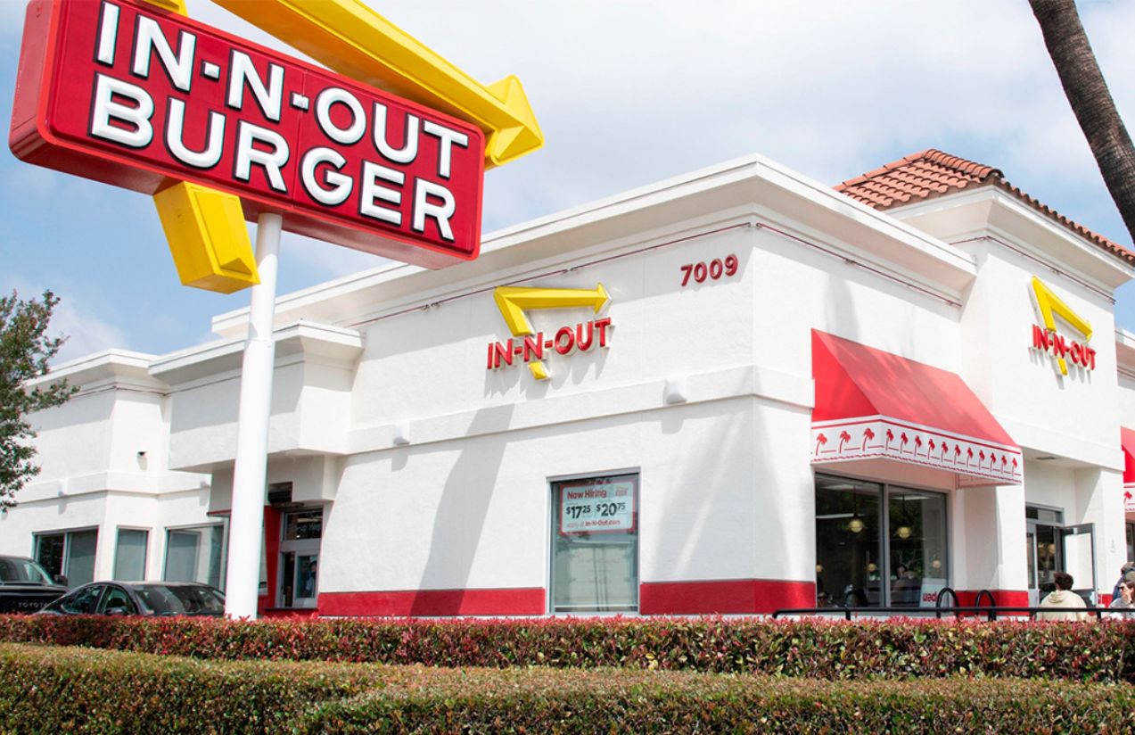 One of the In-N-Out stores with its white facade and its logo in yellow and red colors
