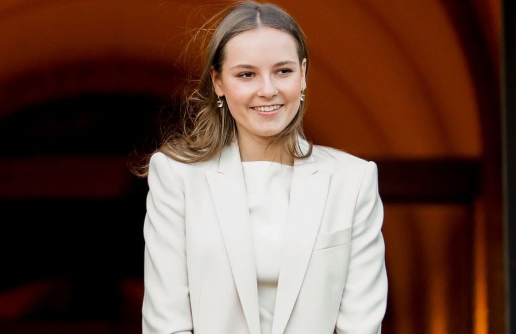 Princess Ingrid posing for photos at an event, wearing a beautiful, elegant white outfit