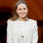 Princess Ingrid posing for photos at an event, wearing a beautiful, elegant white outfit