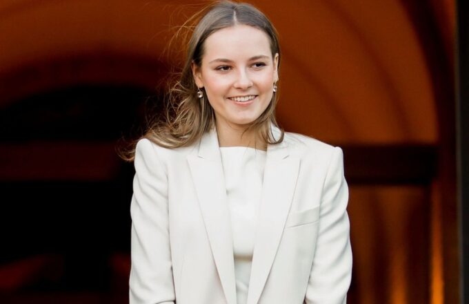 Princess Ingrid posing for photos at an event, wearing a beautiful, elegant white outfit