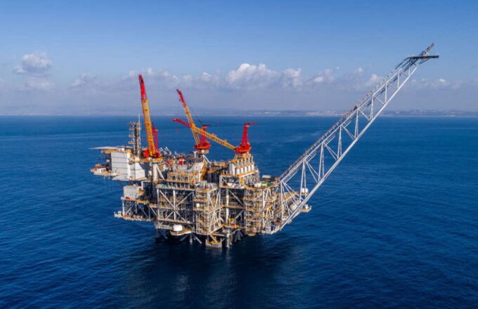 A gigantic Israeli offshore platform in the middle of the sea, with large cranes and pipelines