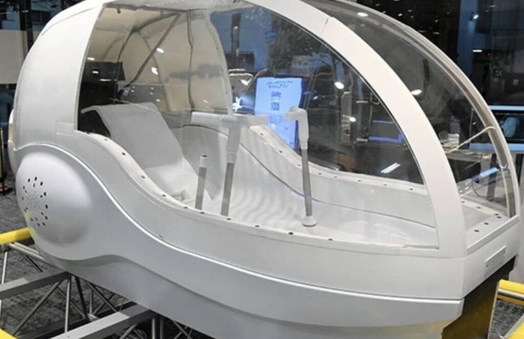 A human washing machine resembling an egg-shaped capsule