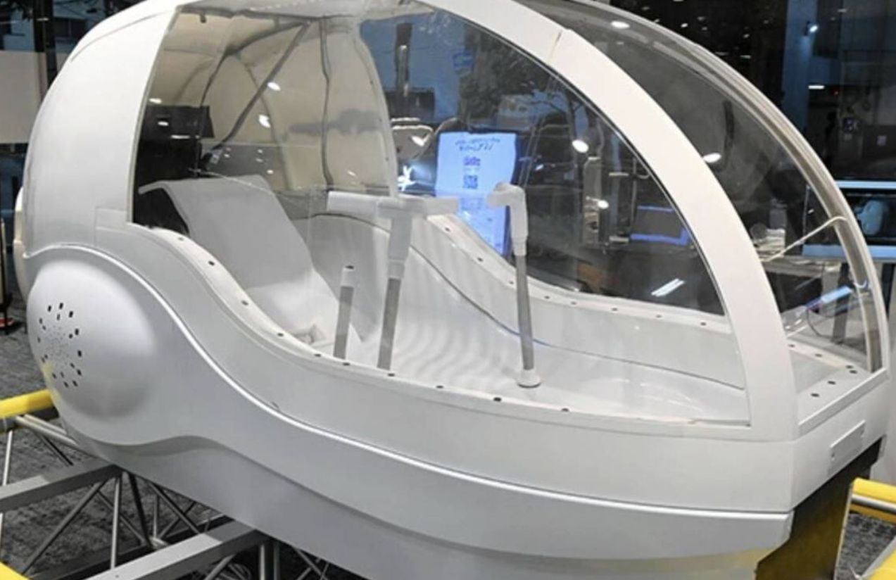 A human washing machine resembling an egg-shaped capsule