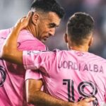 Alba and Busquets speaking charismatically in the middle of a game after scoring a stunning goal