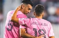 Alba and Busquets speaking charismatically in the middle of a game after scoring a stunning goal