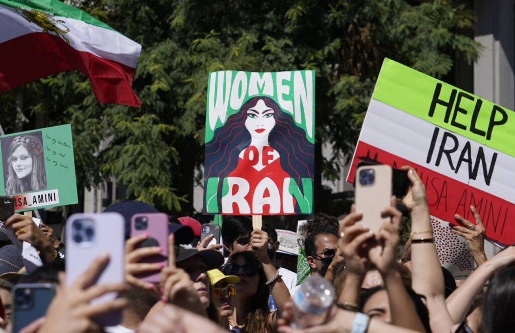 Many people raising placards regarding the recent problems facing Iran