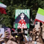 Many people raising placards regarding the recent problems facing Iran