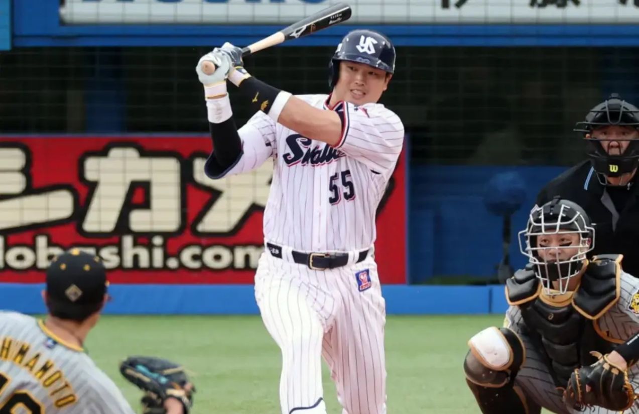 The powerful Japanese hitter swinging and launching a big hit in the middle of a game