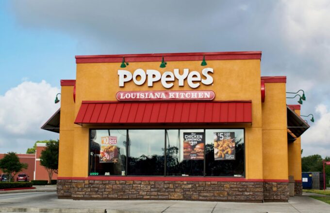 A Popeyes restaurant with its striking orange and red colors