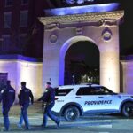 The entrance of Brown University with many officers and police cars at its gates