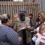 A person conducting surveys with a group of people about asylum in the United States