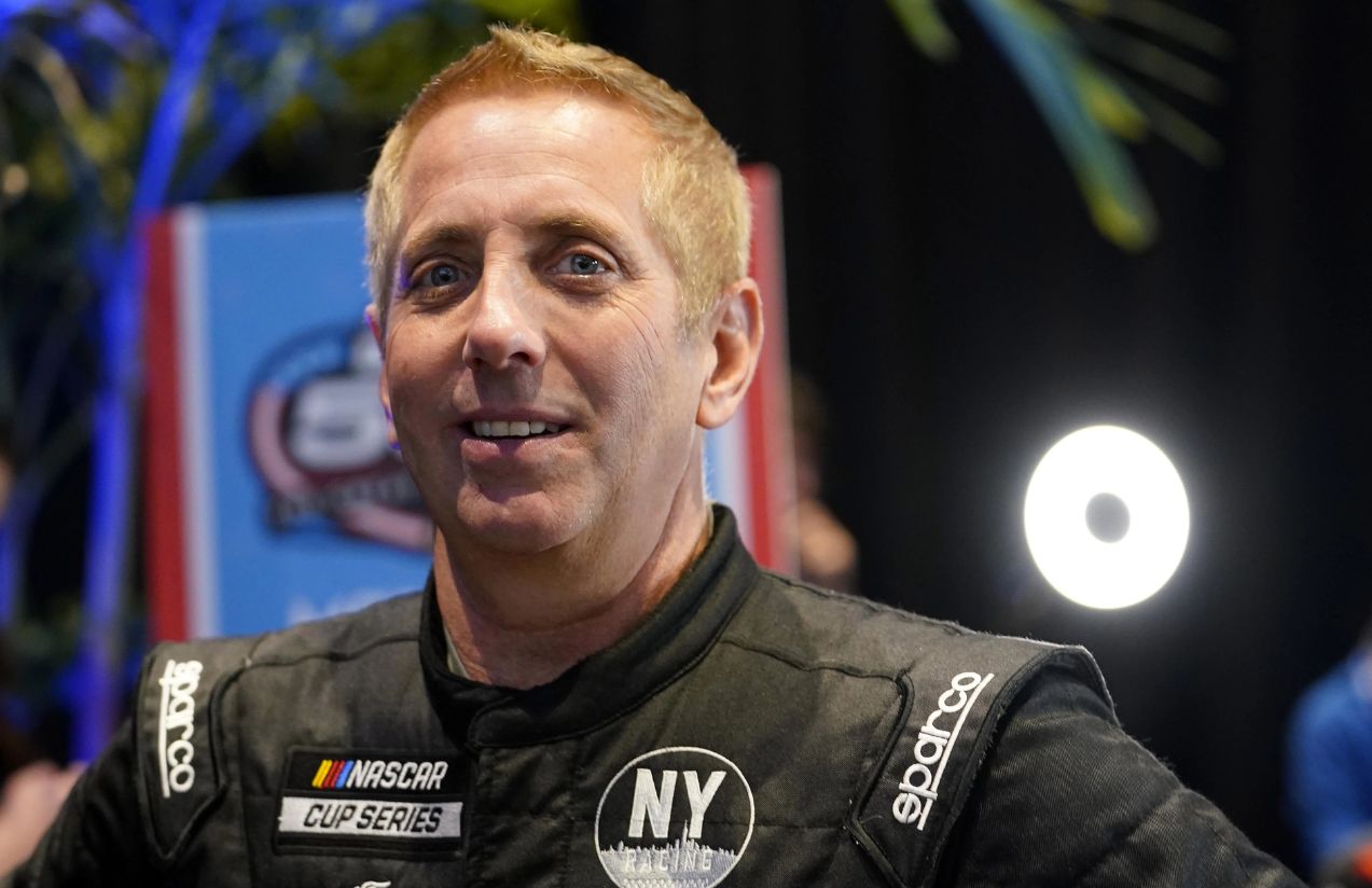 The former NASCAR driver posing for the cameras in his iconic black uniform.