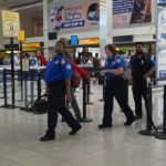 Authorities at a U.S. airport guiding several people to a private room