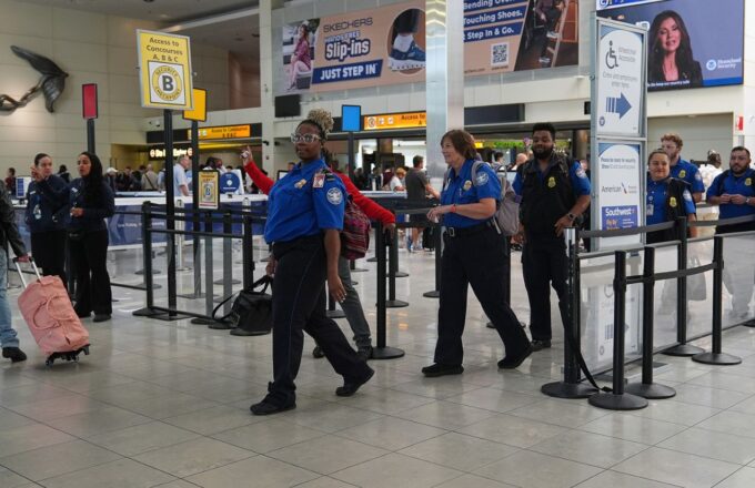 Authorities at a U.S. airport guiding several people to a private room