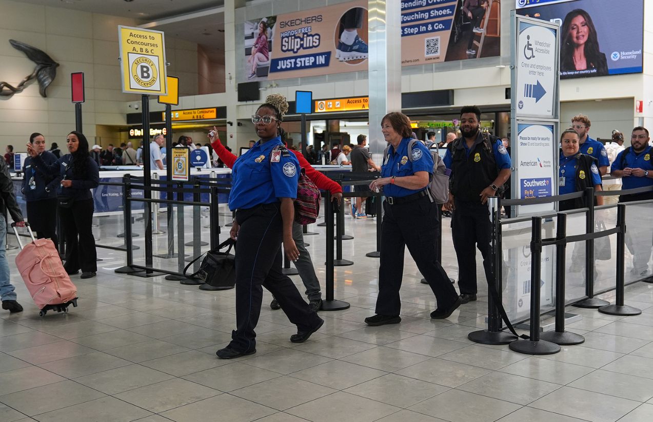 Authorities at a U.S. airport guiding several people to a private room
