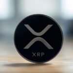 The XRP logo, which is an X, on a table