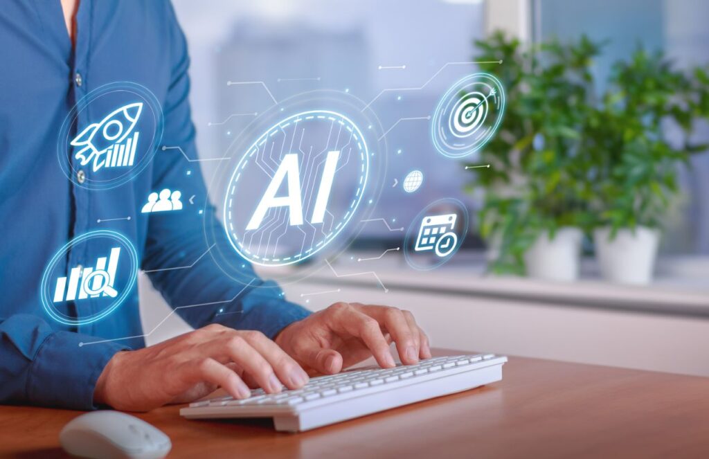 Artificial Intelligence warns which careers could lose relevance in 2026 A person working on their computer while several AI symbols and icons appear on the screen
