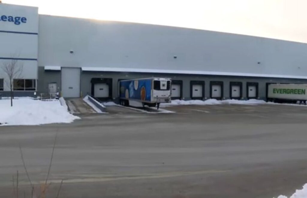 A warehouse with two trucks picking up orders from the robbed seafood distributor