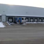 A warehouse with two trucks picking up orders from the robbed seafood distributor