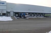 A warehouse with two trucks picking up orders from the robbed seafood distributor
