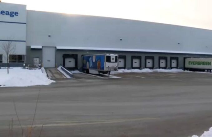 A warehouse with two trucks picking up orders from the robbed seafood distributor