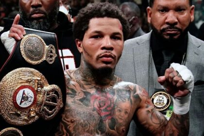 The American boxer raising a championship belt with a very serious expression