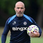 Maresca holding a ball under his left arm during a team training session