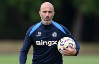 Maresca holding a ball under his left arm during a team training session