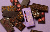 Several chocolate bars on a pink background