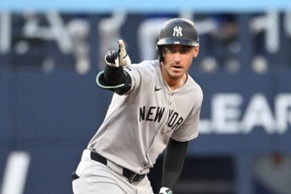 Bellinger celebrating with his teammates after hitting a base hit during a game