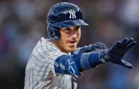 Cody celebrating a hit while wearing the New York Yankees uniform