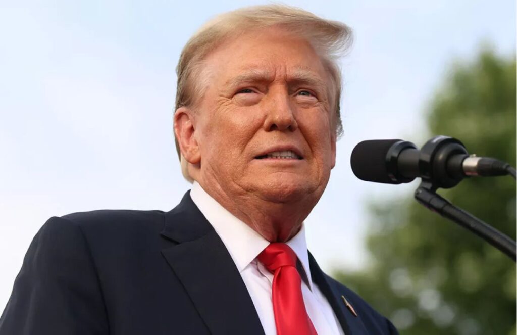 Donald Trump giving an outdoor press conference where he appears very smiling