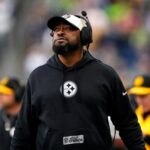 The current Steelers coach walking along the sideline with a defiant attitude