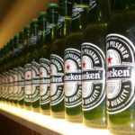 A shelf displaying many Heineken brand beers