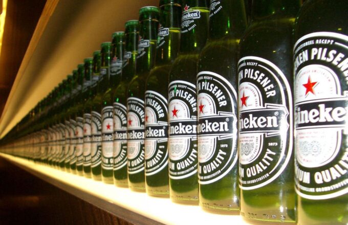 A shelf displaying many Heineken brand beers