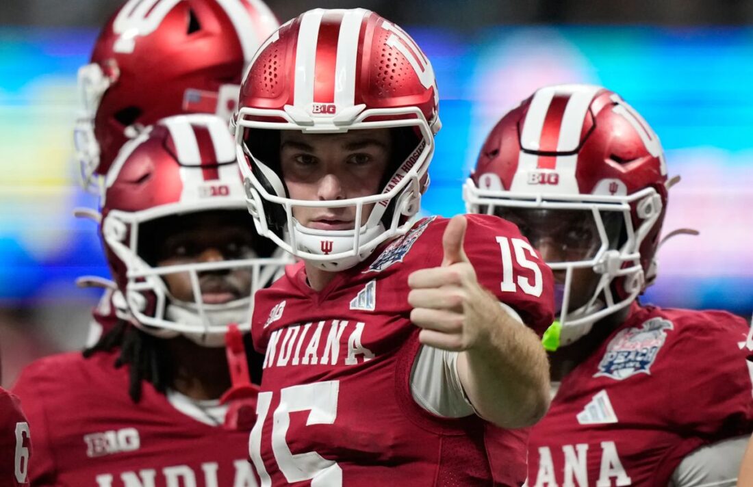 Several Indiana players celebrating a touchdown with their quarterback