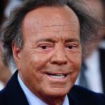 A very close-up photo of the singer’s face, where he appears very tanned and smiling