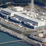 An aerial view of the nuclear power plant with its buildings and tall towers