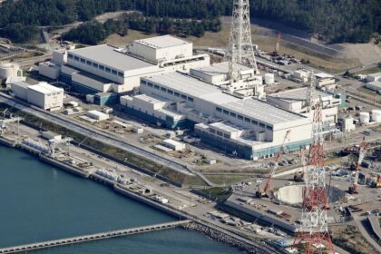 An aerial view of the nuclear power plant with its buildings and tall towers