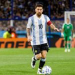 The Argentine star controlling the ball in the middle of the field while wearing Argentina’s national team jersey