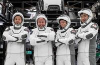 The four experienced astronauts posing for a photo in their spacesuits before the launch of their mission